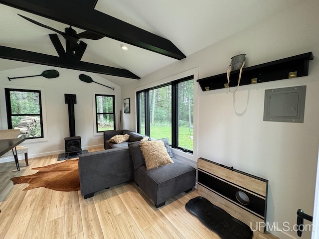 living room with plenty of natural light, vaulted ceiling with beams, light wood finished floors, and electric panel
