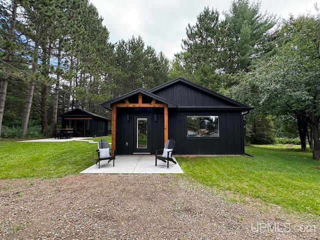 exterior space featuring a front lawn and a patio