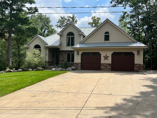 view of front of house with a garage and a front yard