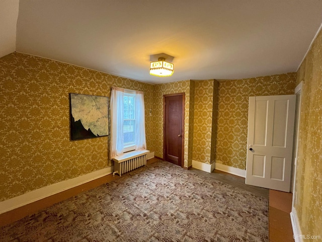 interior space with radiator and wood-type flooring