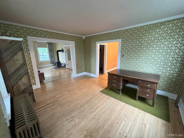 interior space with light wood-type flooring and crown molding