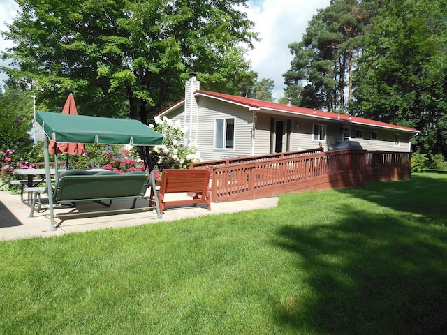 exterior space featuring a lawn and a wooden deck