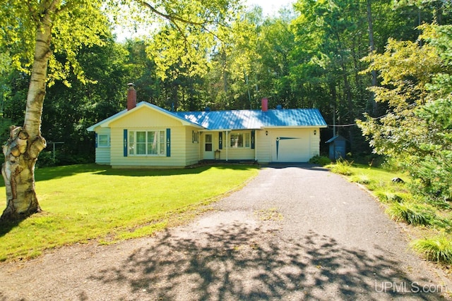 single story home featuring a garage and a front lawn