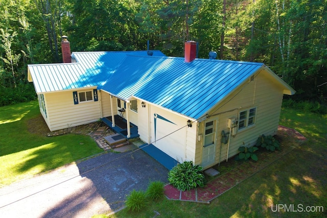 exterior space featuring a garage and a front yard