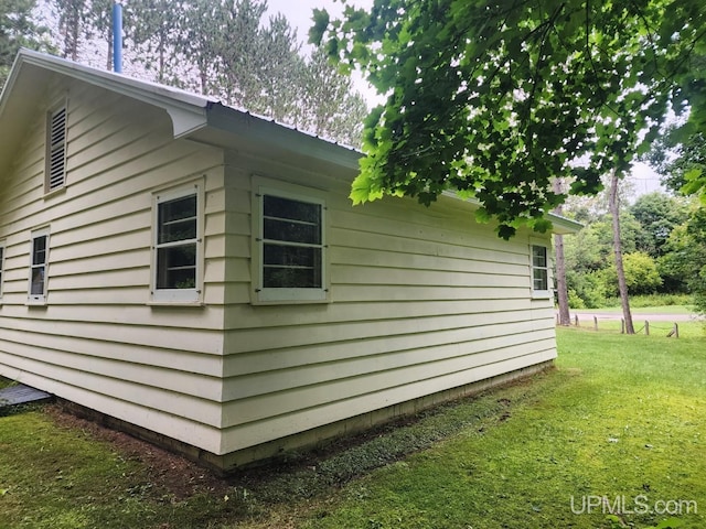 view of side of property with a yard