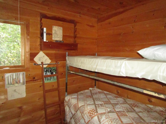 bedroom with wooden walls