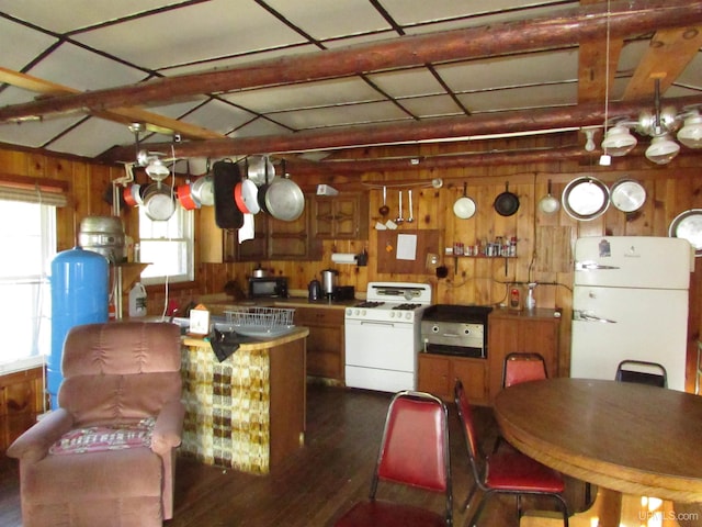 kitchen featuring wood walls, white appliances, dark hardwood / wood-style flooring, and a notable chandelier