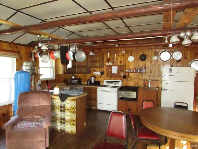 kitchen featuring wood walls, brown cabinetry, white appliances, and dark wood-style floors