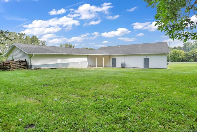 back of house featuring cooling unit and a yard