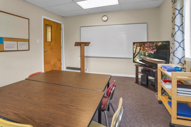 interior space with a paneled ceiling and carpet