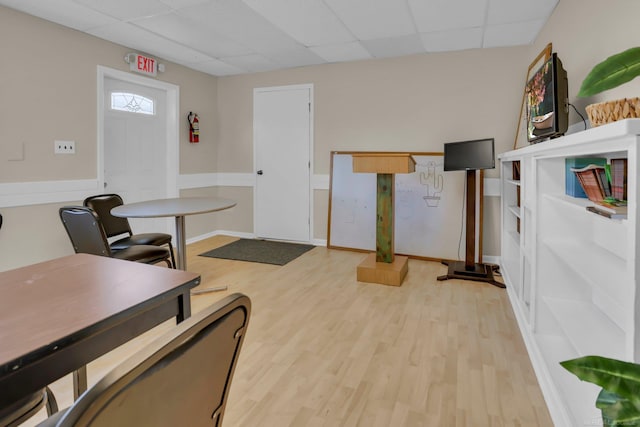 office with light wood-type flooring and a paneled ceiling