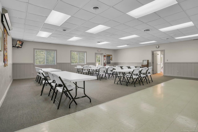 dining room with a drop ceiling and carpet floors