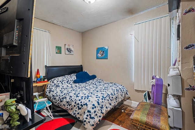 bedroom featuring dark hardwood / wood-style flooring