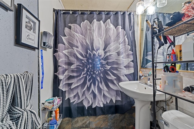 bathroom with a shower with curtain and toilet