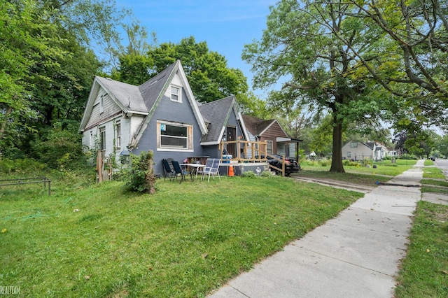 view of front of home featuring a deck and a front yard