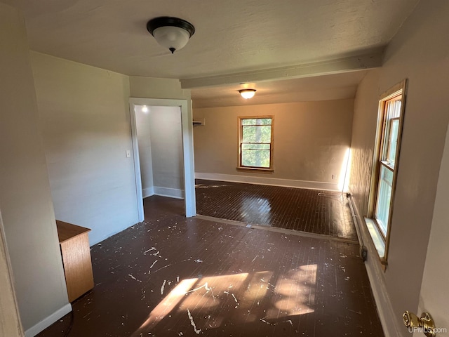 unfurnished room with dark hardwood / wood-style flooring