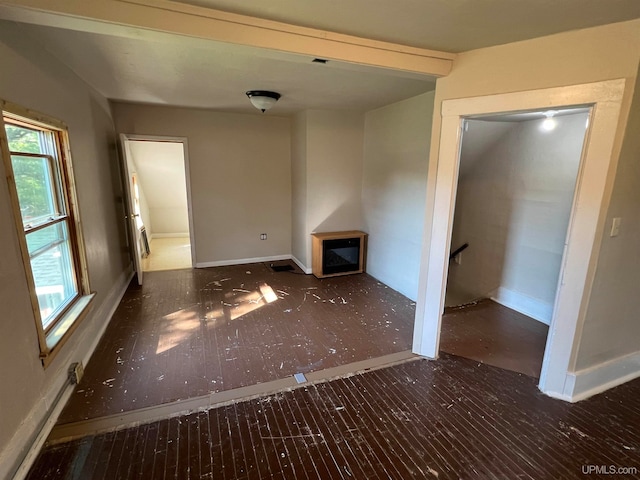 unfurnished living room featuring dark hardwood / wood-style floors