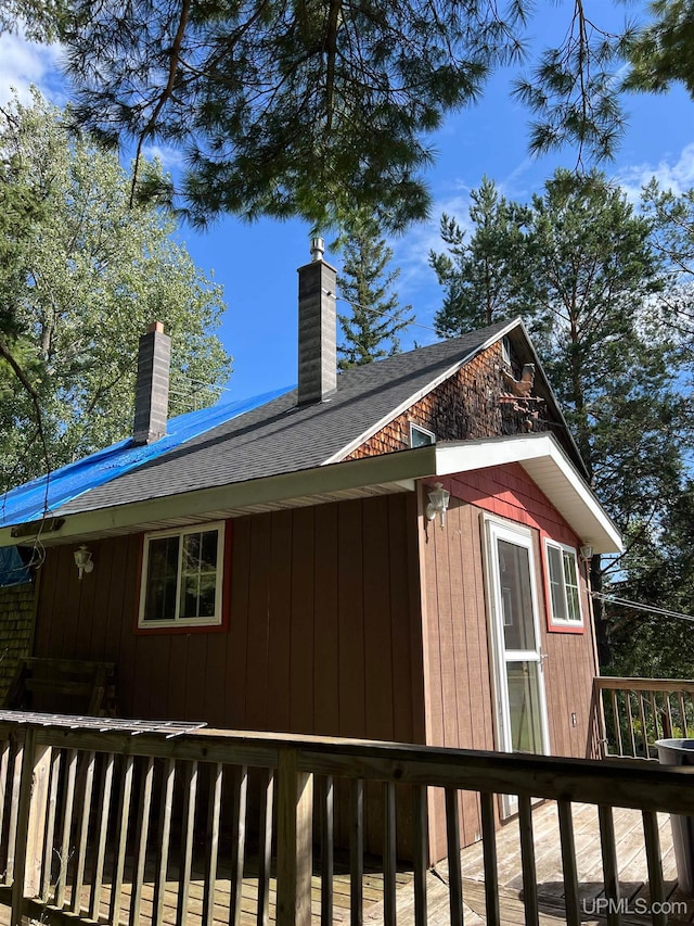 view of side of property featuring a wooden deck