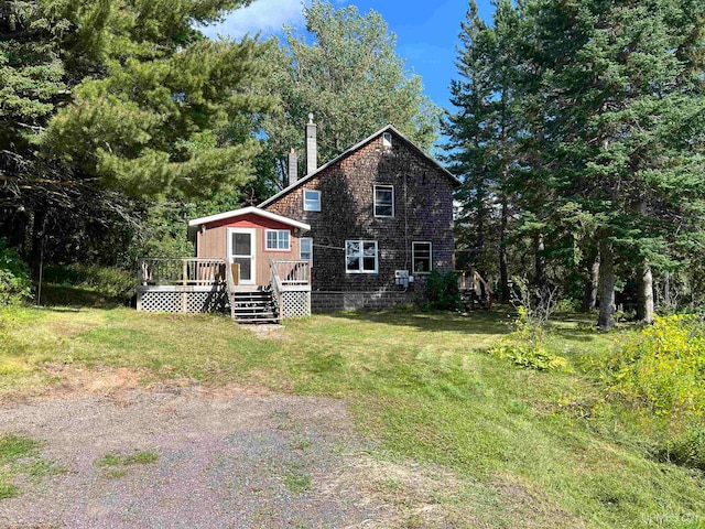 exterior space with a lawn and a deck