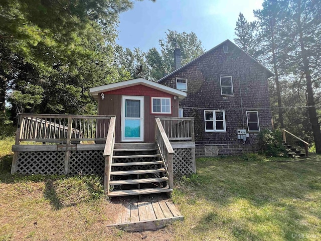 back of house featuring a yard and a wooden deck