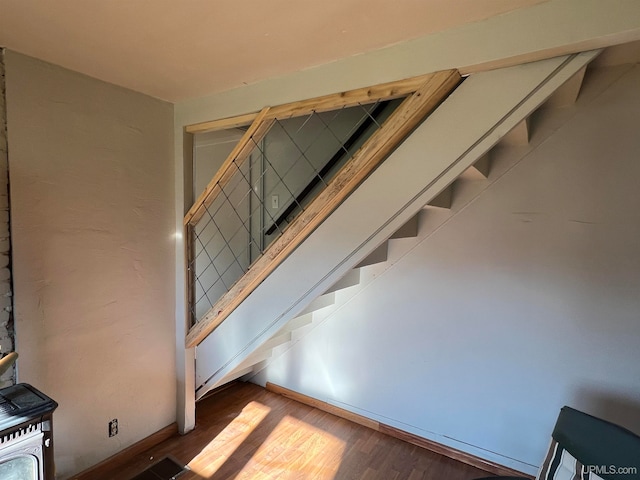 stairway with hardwood / wood-style flooring