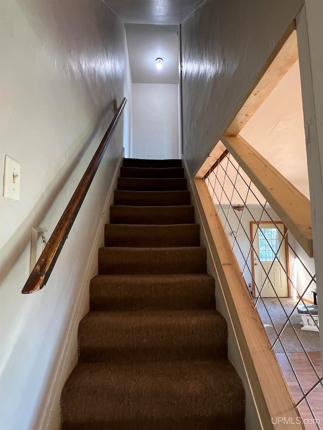 staircase featuring tile patterned flooring