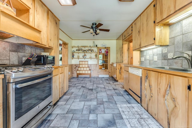 kitchen with stainless steel gas stove, sink, white dishwasher, ceiling fan, and decorative backsplash