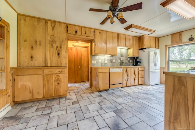 kitchen with baseboard heating, ceiling fan, backsplash, and white appliances