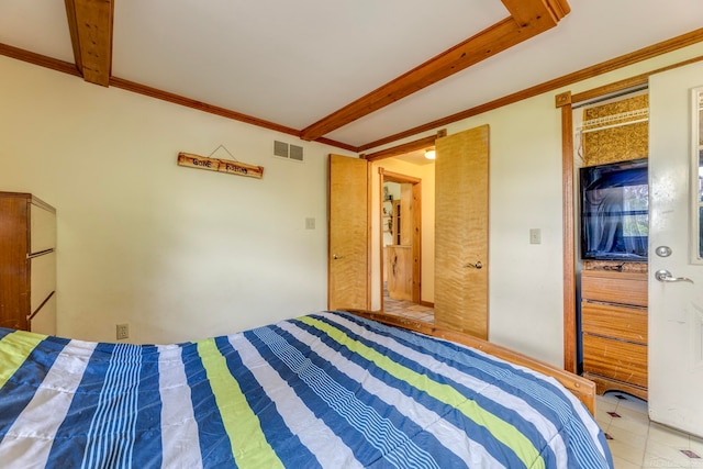 bedroom with ornamental molding, beamed ceiling, and tile patterned floors