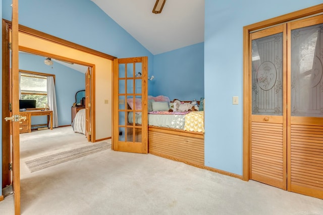 carpeted bedroom featuring lofted ceiling and ceiling fan