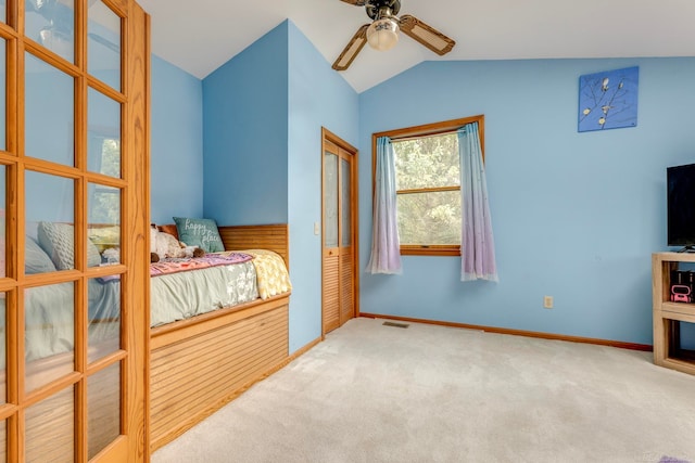 carpeted bedroom featuring a closet, ceiling fan, and vaulted ceiling