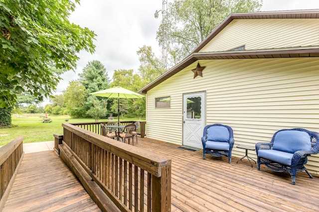 wooden deck with a lawn