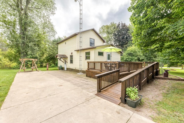 rear view of property featuring a patio area and a wooden deck