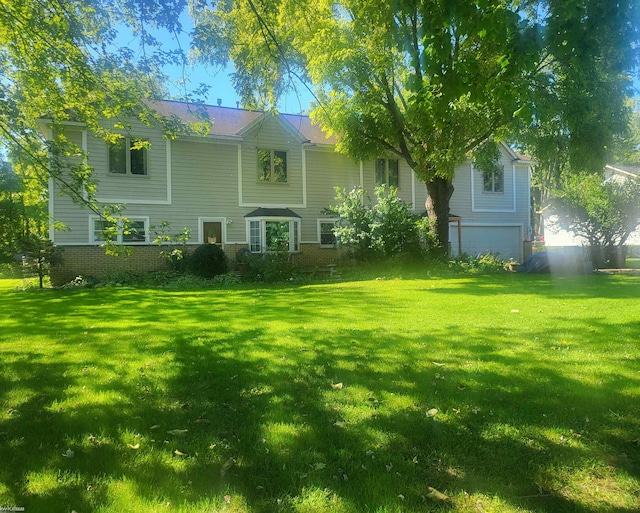 rear view of house featuring a yard