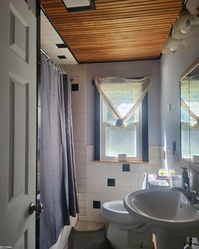 bathroom featuring wooden ceiling, a shower with curtain, tile walls, tile patterned floors, and toilet