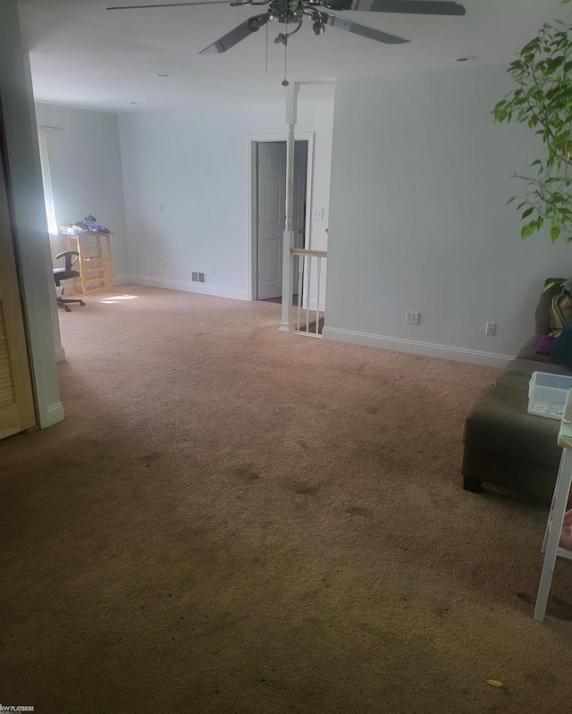 interior space with carpet floors and ceiling fan