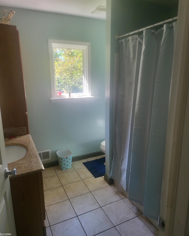 bathroom with curtained shower, vanity, toilet, and tile patterned floors