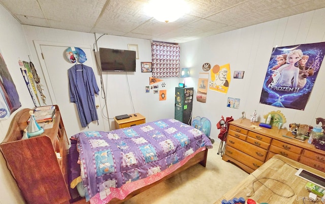 bedroom with wooden walls and carpet