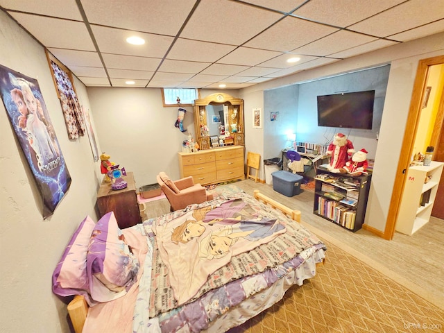 bedroom with light carpet and a drop ceiling