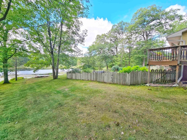 view of yard featuring a deck with water view