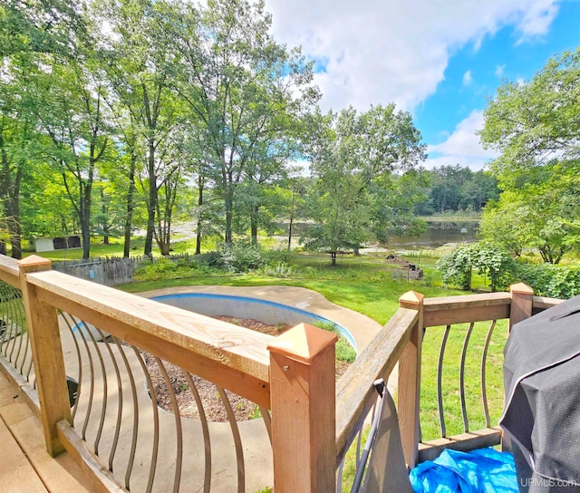 wooden deck featuring a water view and a yard