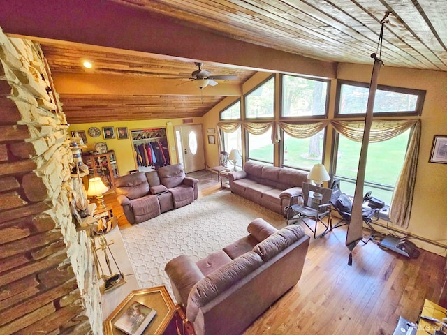 living room with a fireplace, hardwood / wood-style floors, ceiling fan, vaulted ceiling with beams, and wooden ceiling