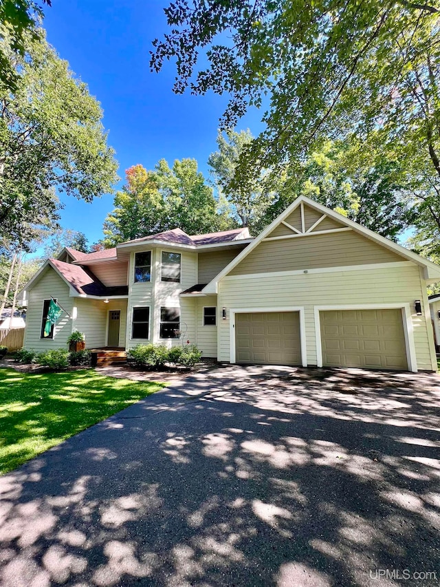 view of front of home featuring a garage and a front lawn