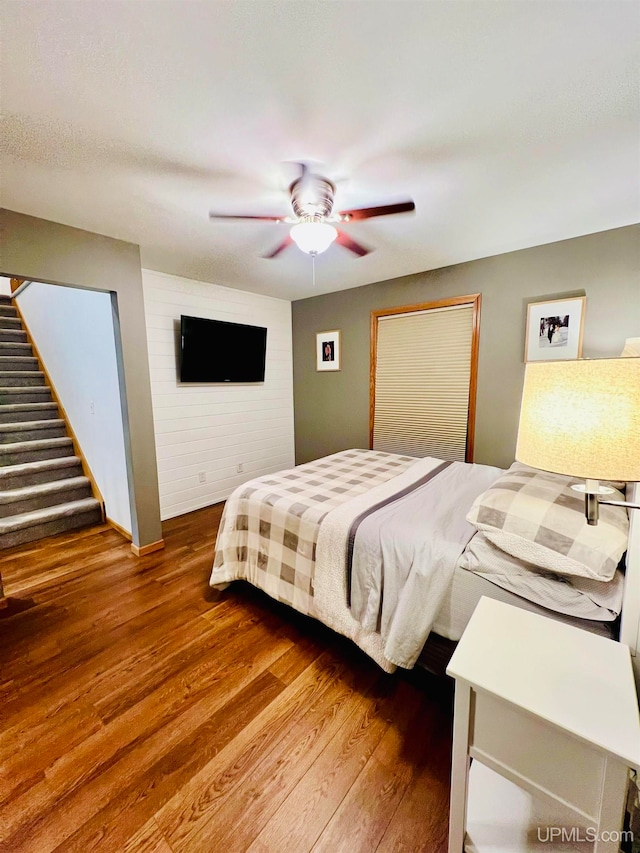 bedroom with ceiling fan and dark hardwood / wood-style flooring