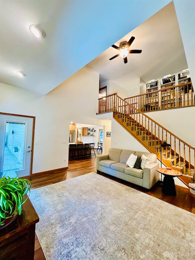 living room featuring hardwood / wood-style flooring and ceiling fan