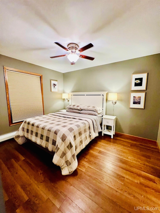 bedroom with ceiling fan and hardwood / wood-style floors