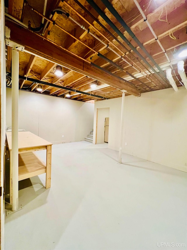 basement with white fridge