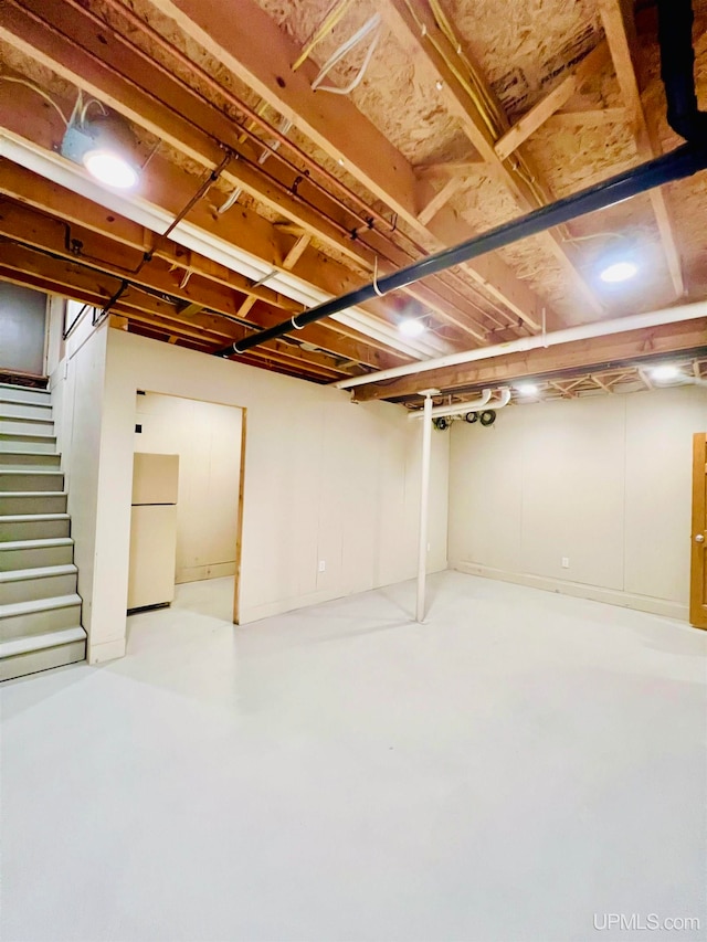 basement featuring white fridge