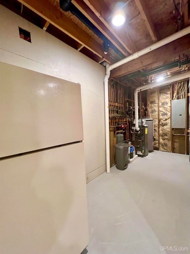 basement with white refrigerator and electric panel