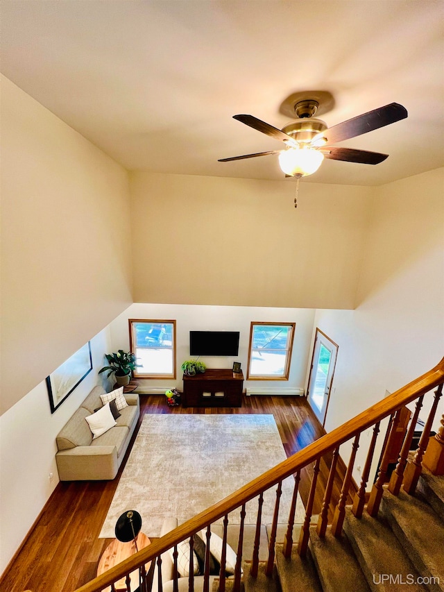 living room with a healthy amount of sunlight, ceiling fan, and hardwood / wood-style flooring